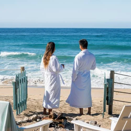Beachfront Bungalows in Todos Santos A couple at the beachfront tented suites' private patio overlooking the Pacific Ocean at Villa Santa Cruz